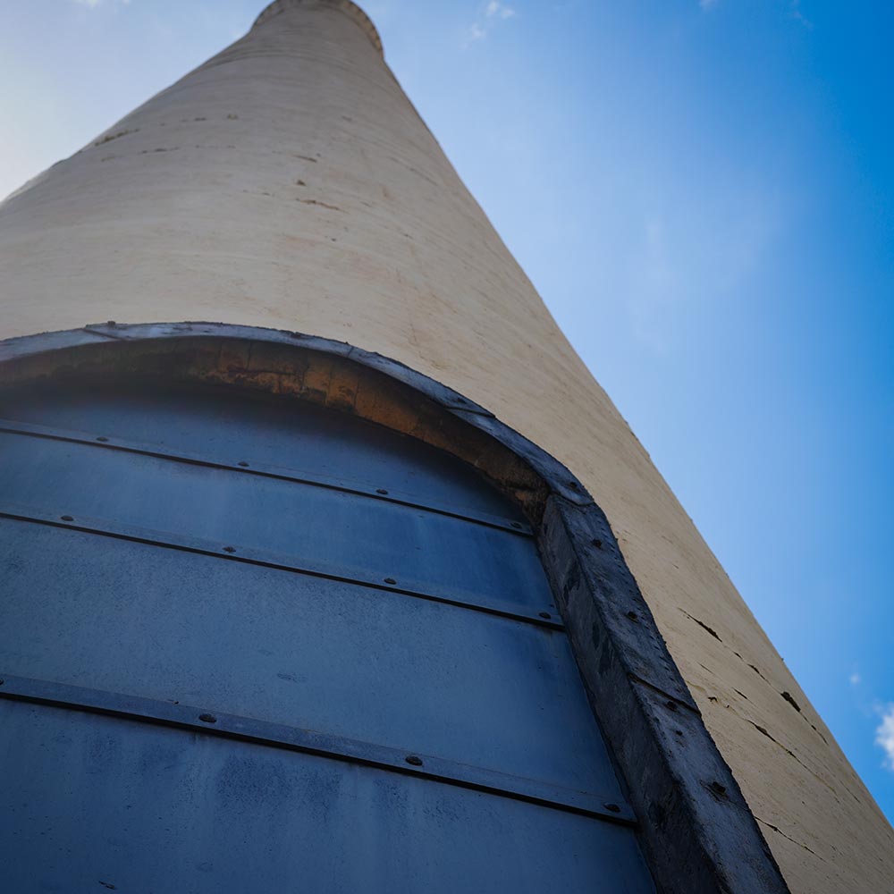 image of historic smokestack and trains in Lahaina.